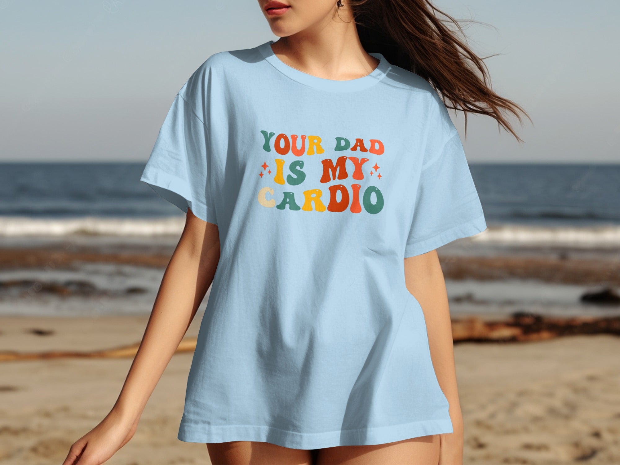 Light blue t-shirt with "YOUR DAD IS MY CARDIO" text in retro lettering.