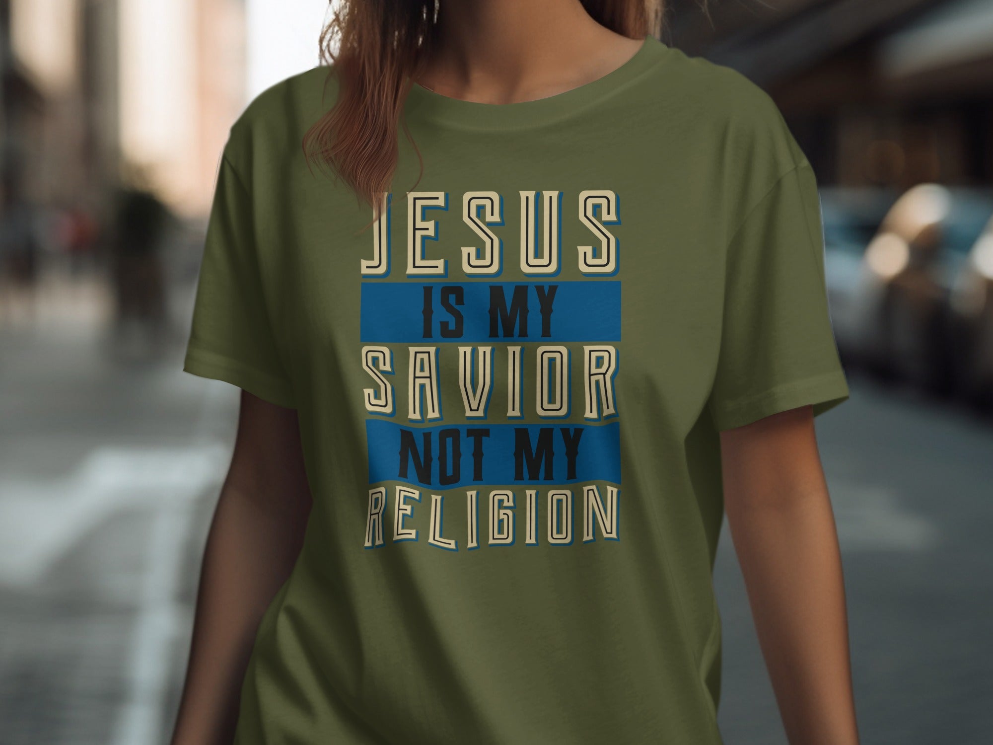 Green t-shirt with text "JESUS IS MY SAVIOR NOT MY RELIGION".