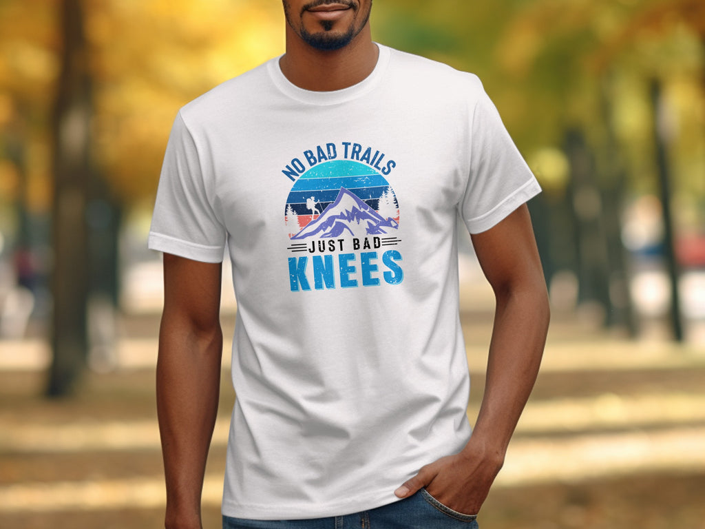 White t-shirt with "No Bad Trails Just Bad Knees" graphic.