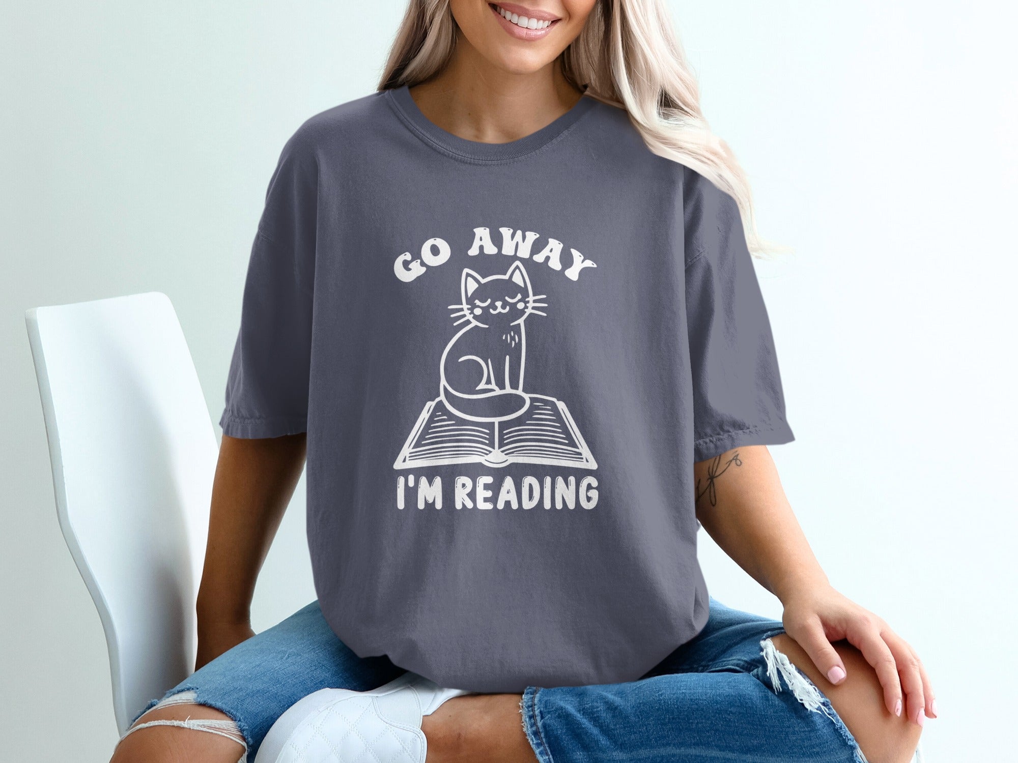Grey t-shirt with white text "GO AWAY" and a cat on a book "I'M READING".