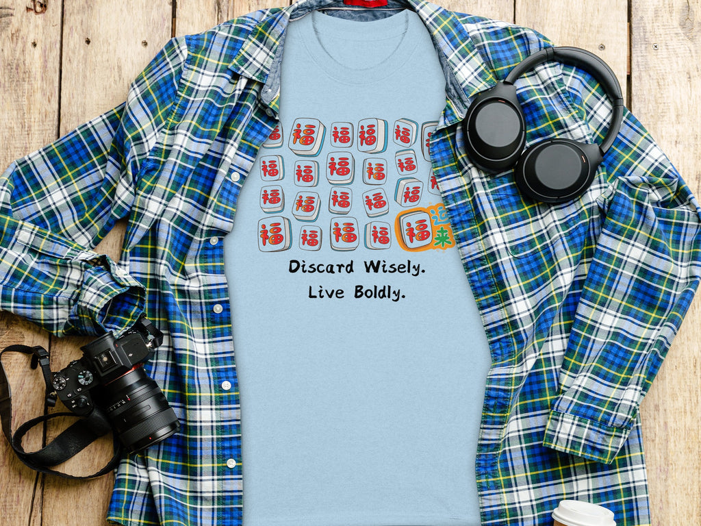 Light blue t-shirt with mahjong tiles and text "Discard Wisely. Live Boldly."