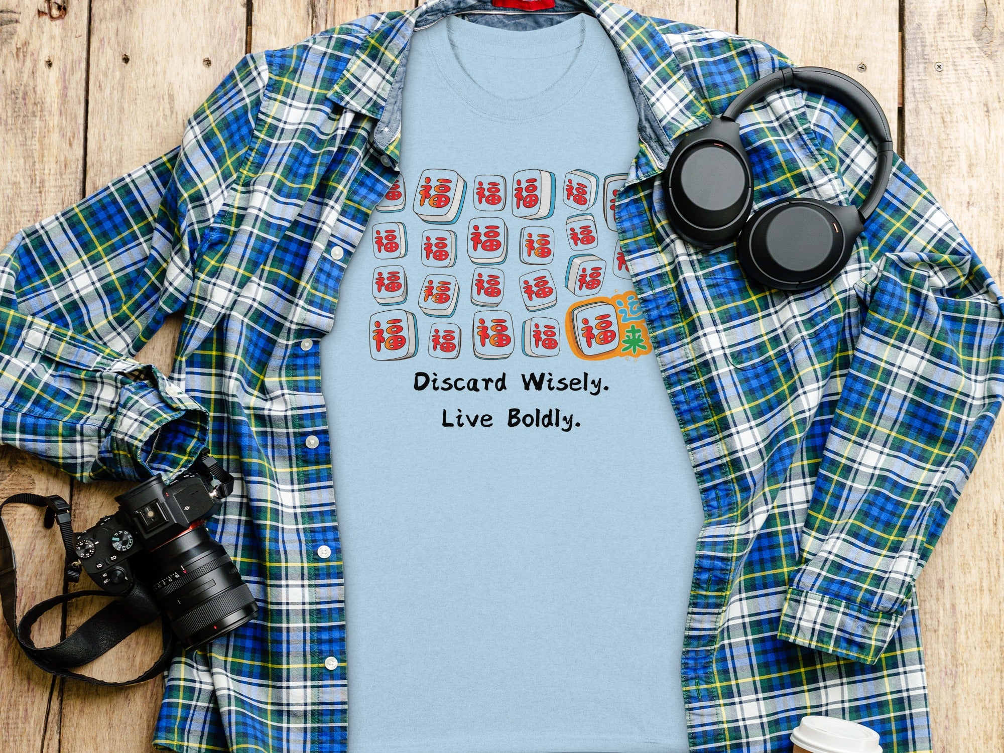 Light blue t-shirt with mahjong tiles and text "Discard Wisely. Live Boldly."