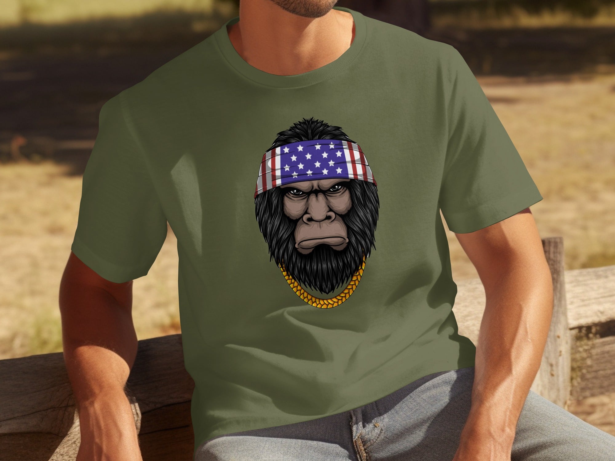 Green t-shirt with Bigfoot wearing an American flag bandana and gold chain graphic.