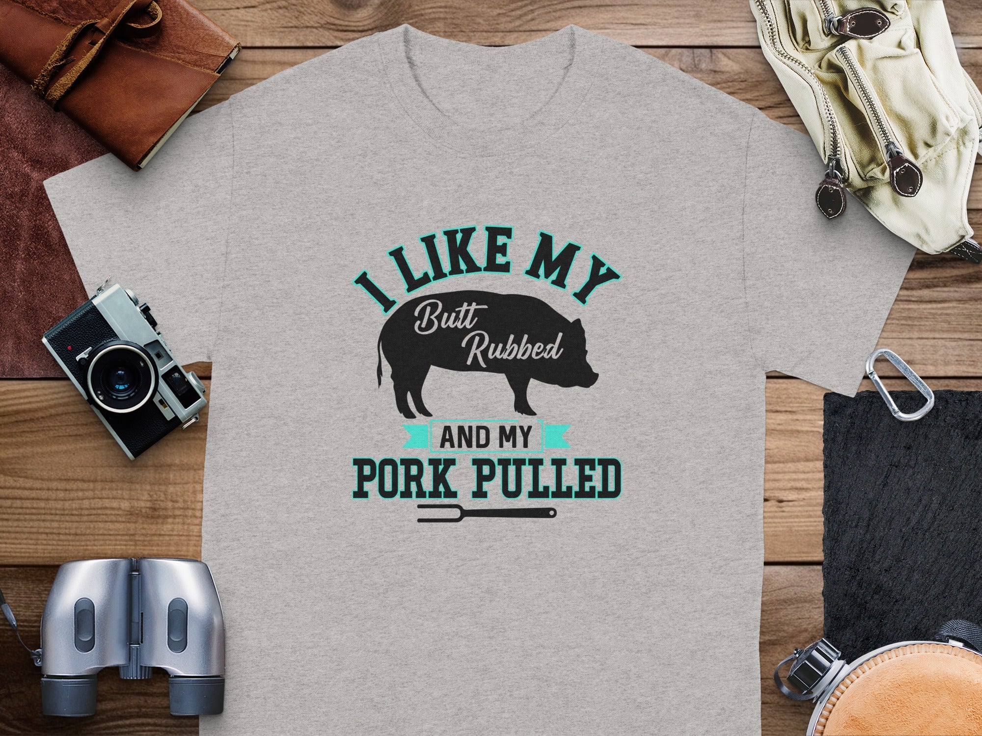 Grey t-shirt with "I like my butt rubbed and my pork pulled" text and pig graphic.