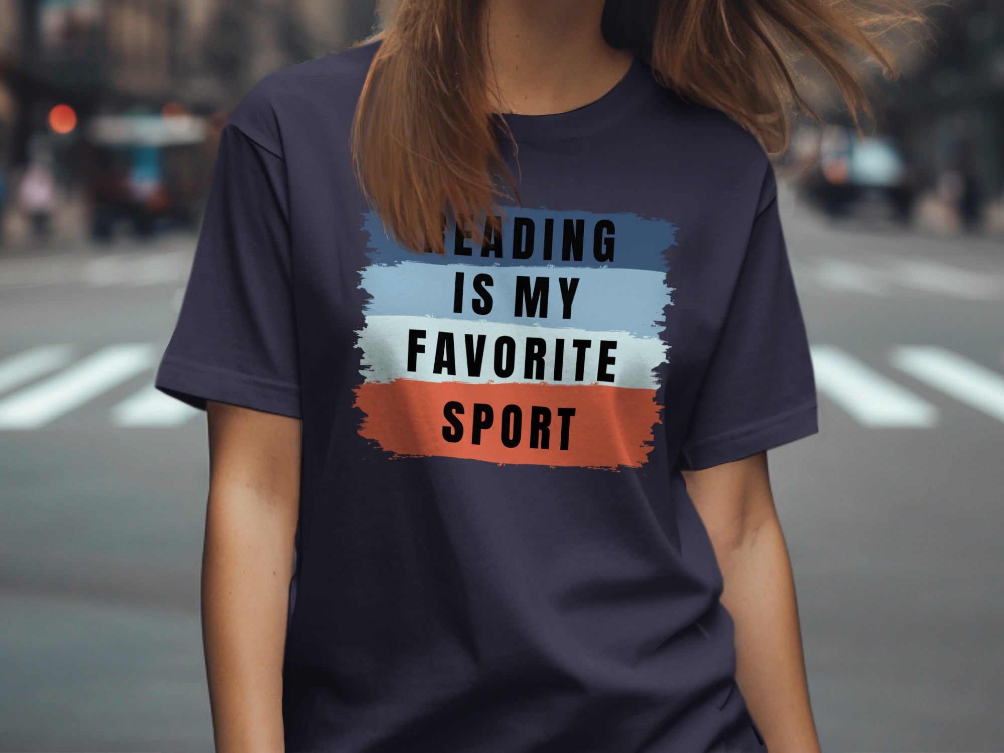 Navy t-shirt with "Reading Is My Favorite Sport" text on colorful brush strokes.