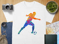 White t-shirt with colorful soccer player graphic and soccer ball.