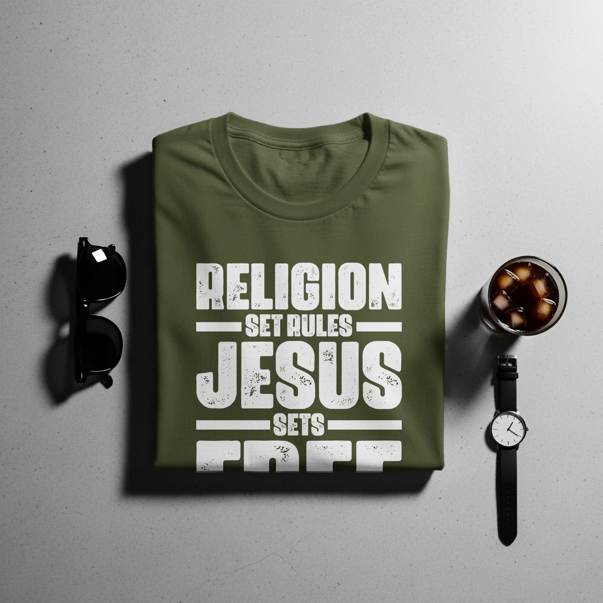 Olive green t-shirt with distressed white text "RELIGION SET RULES JESUS SETS FREE".