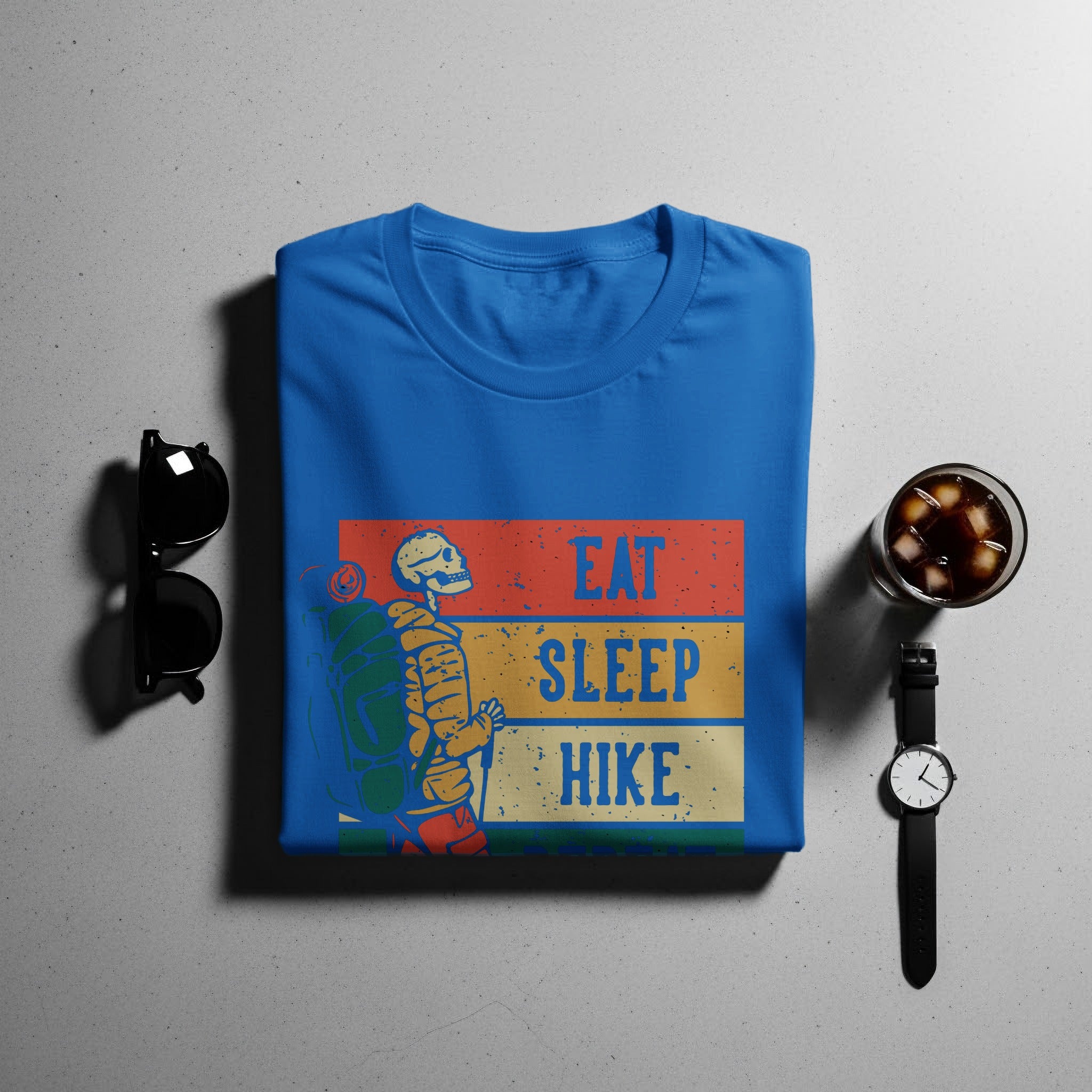 Blue t-shirt with skeleton hiker graphic and "Eat Sleep Hike" text.