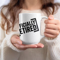 White mug with black text that reads "OFFICIALLY RETIRED"