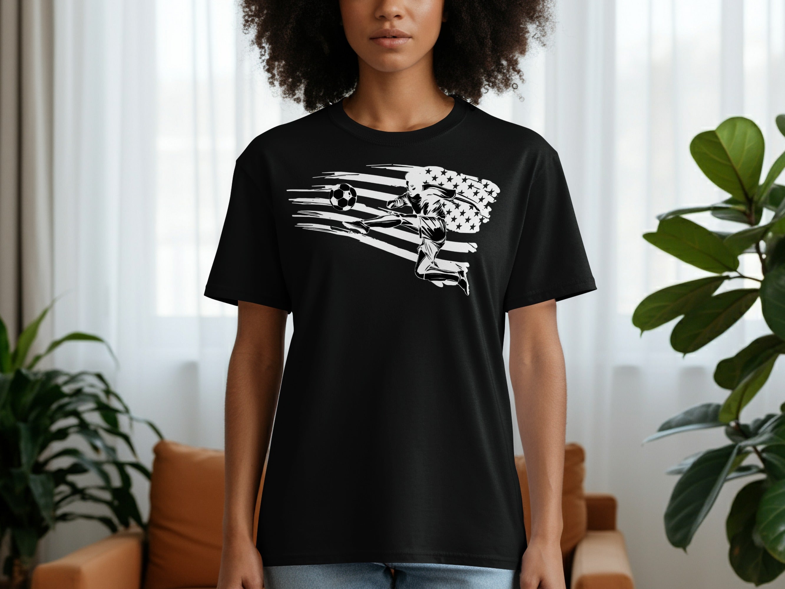 Black t-shirt with a white graphic of a soccer player kicking a ball with an American flag.