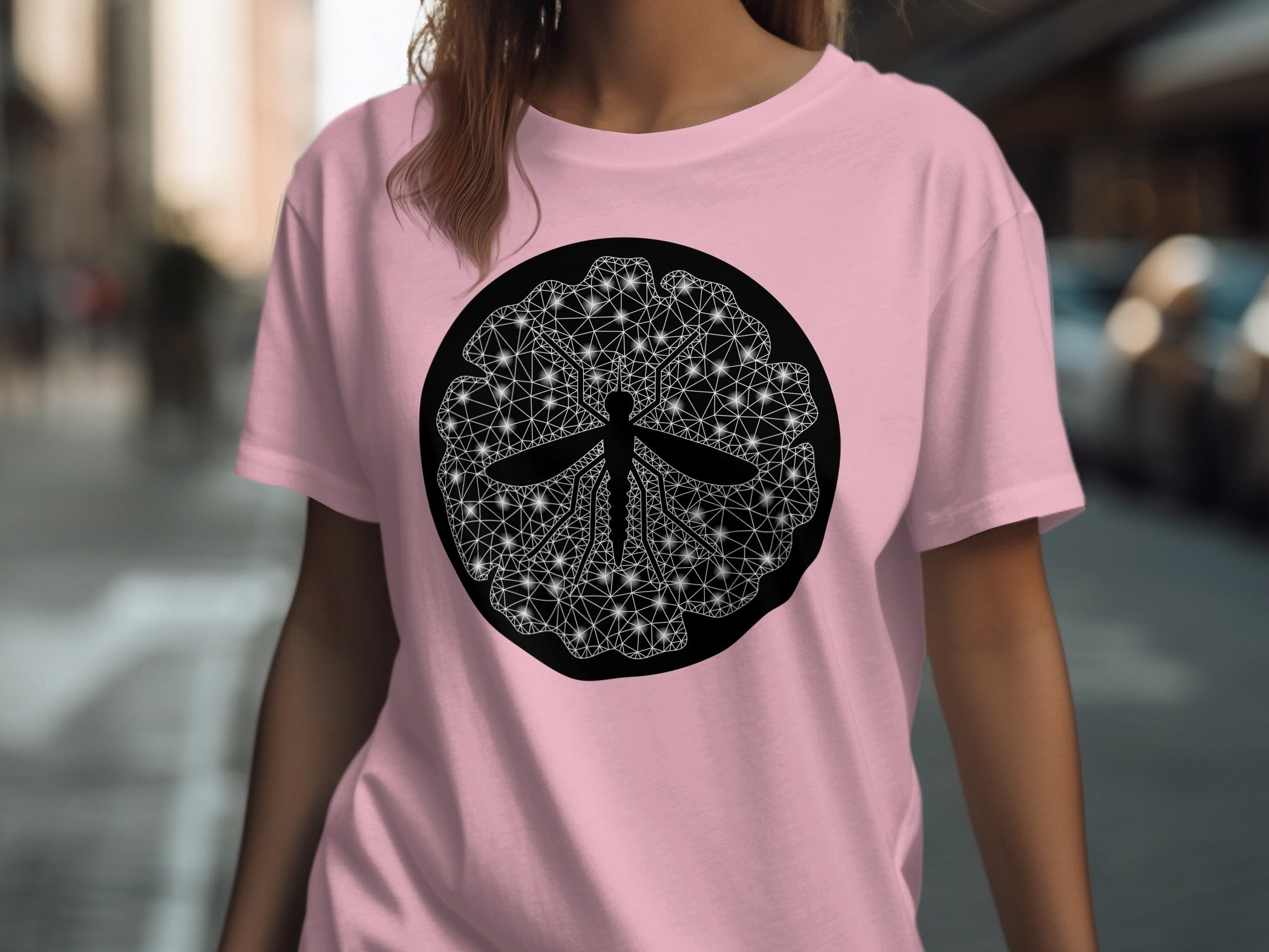 Pink t-shirt with a black circular graphic of a stylized insect in white geometric lines.