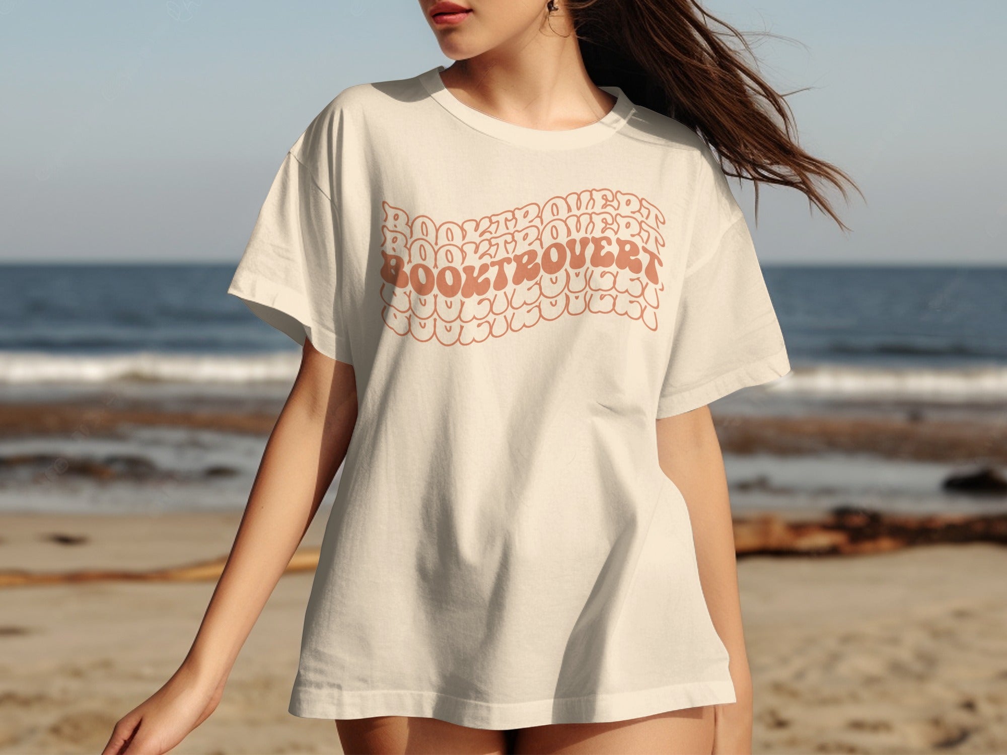 Cream t-shirt with "BOOKTROVERT" text in a wavy, retro font.