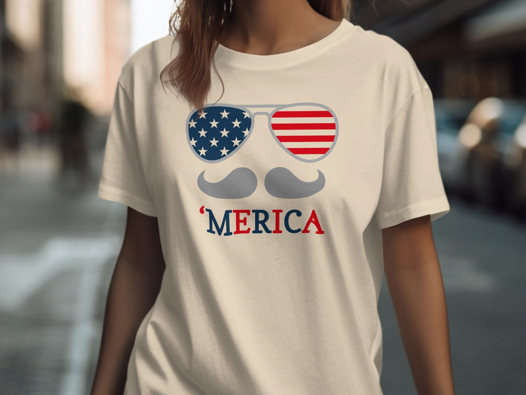 Cream t-shirt with American flag sunglasses, mustache, and 'MERICA graphic.