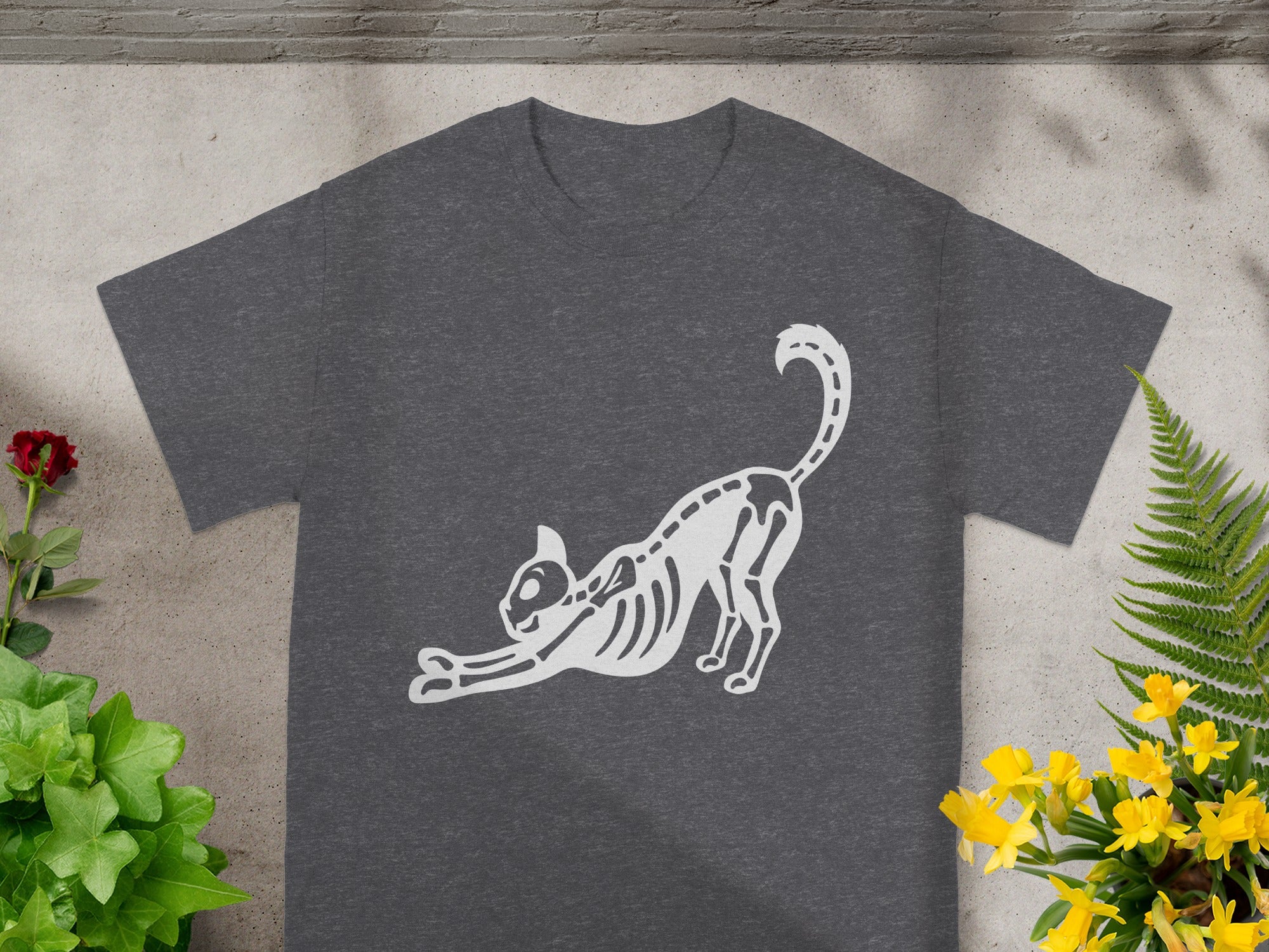 Dark grey t-shirt with a white outline of a stretching cat skeleton.