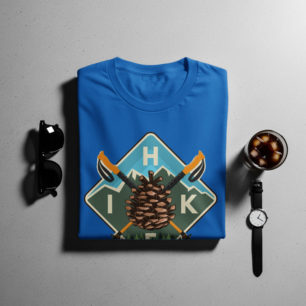 Blue t-shirt with H IK text on a pine cone and mountain graphic.