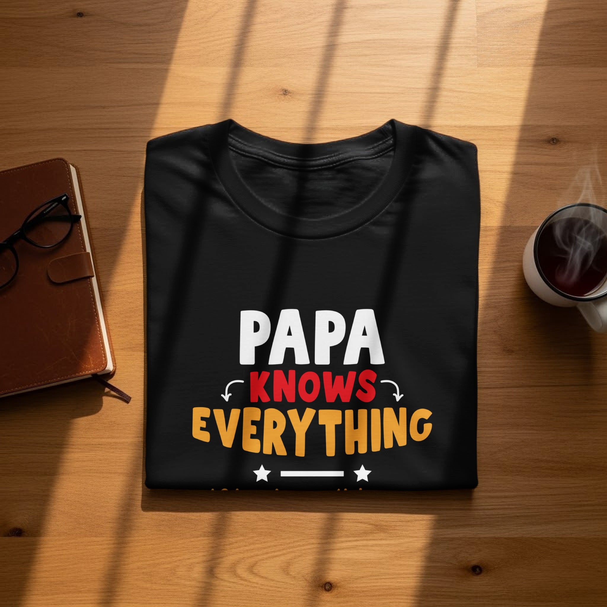 Black t-shirt with "PAPA KNOWS EVERYTHING" text and decorative stars.