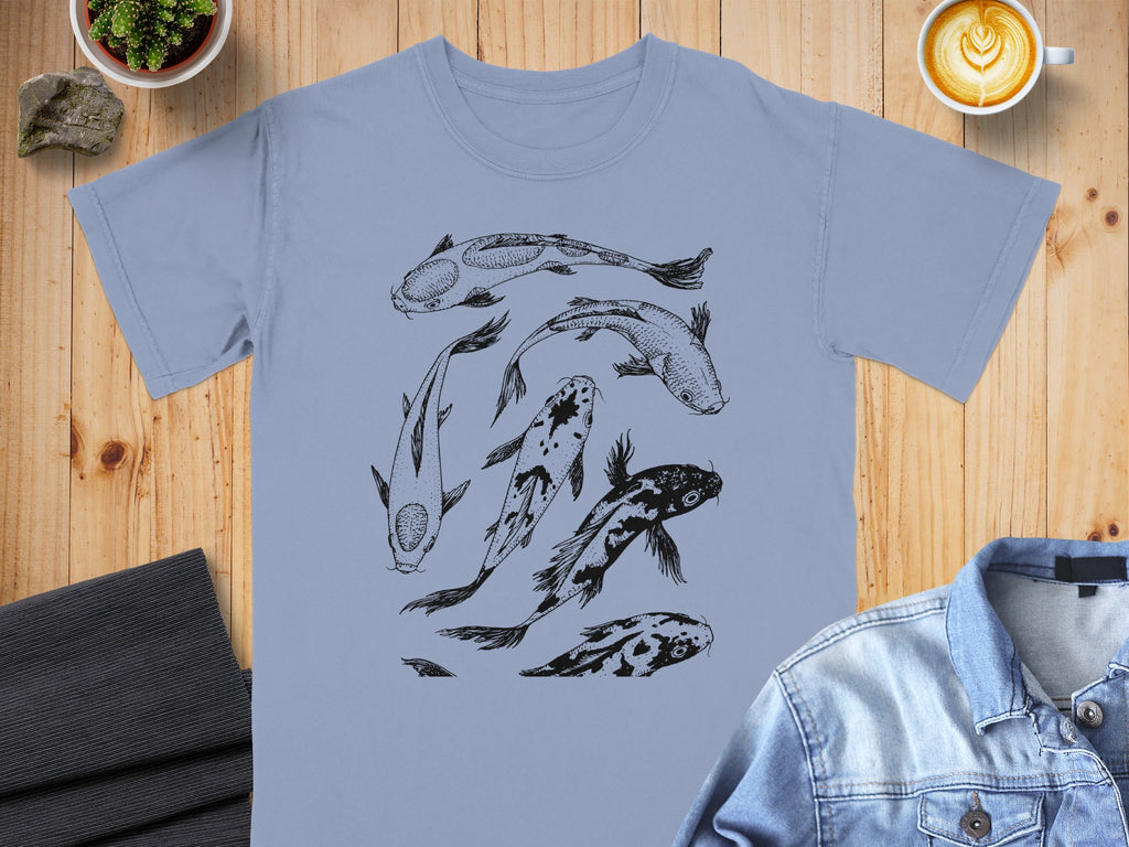 Light blue t-shirt with a black line drawing of koi fish swimming in a circular pattern.