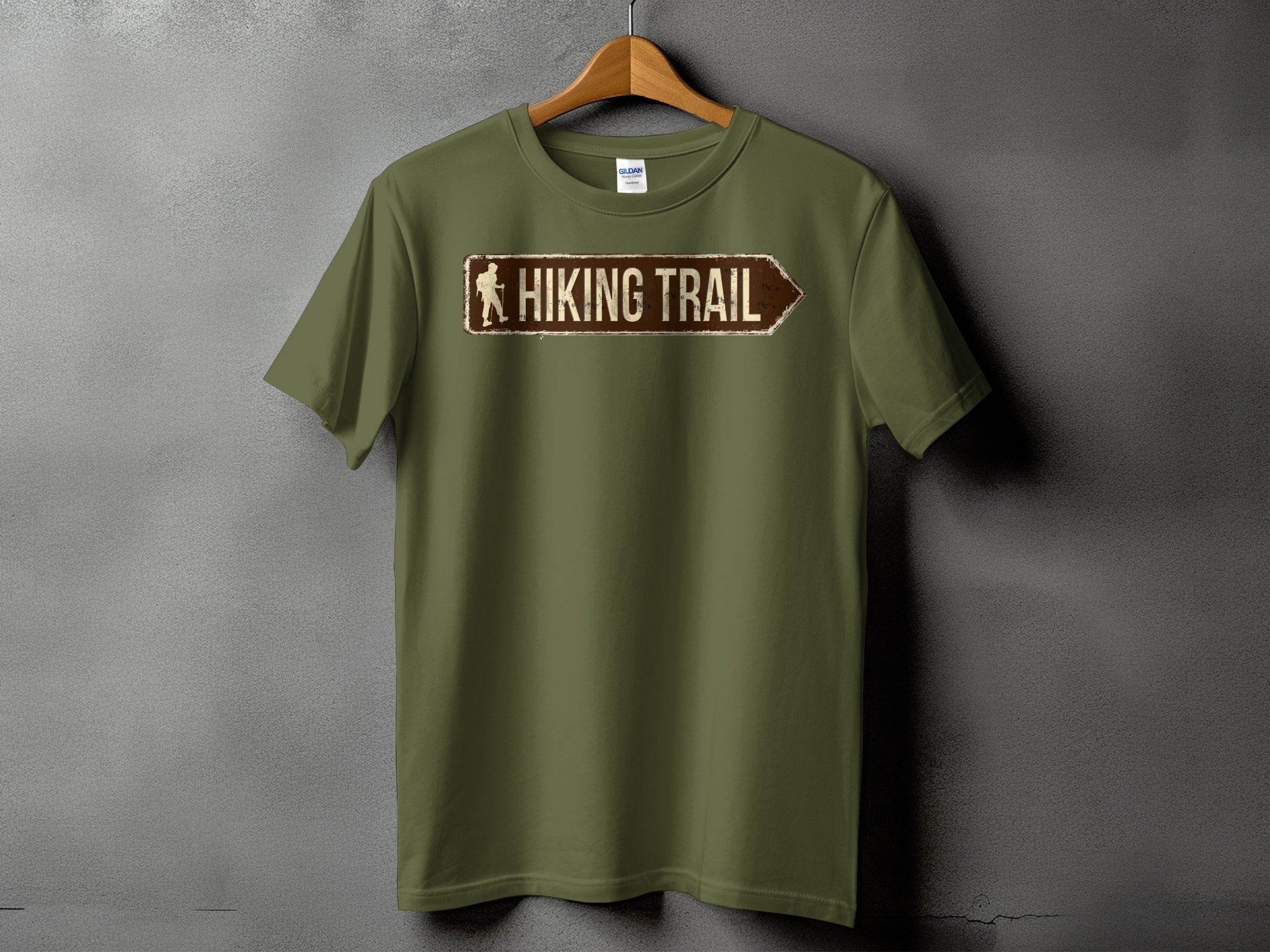 Olive green t-shirt with a distressed sign graphic reading "HIKING TRAIL".