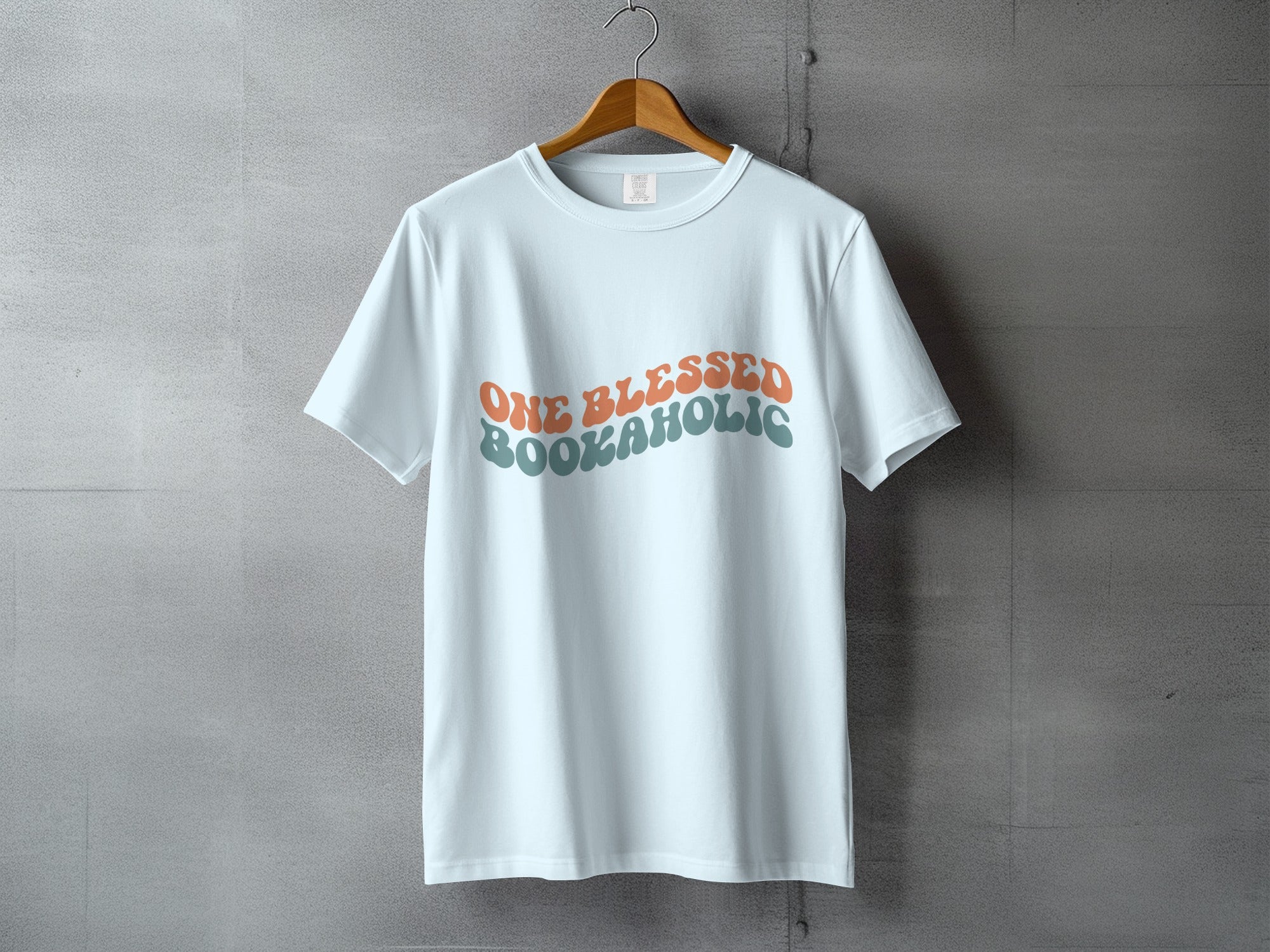 White t-shirt with retro text reading "ONE BLESSED BOOKAHOLIC".