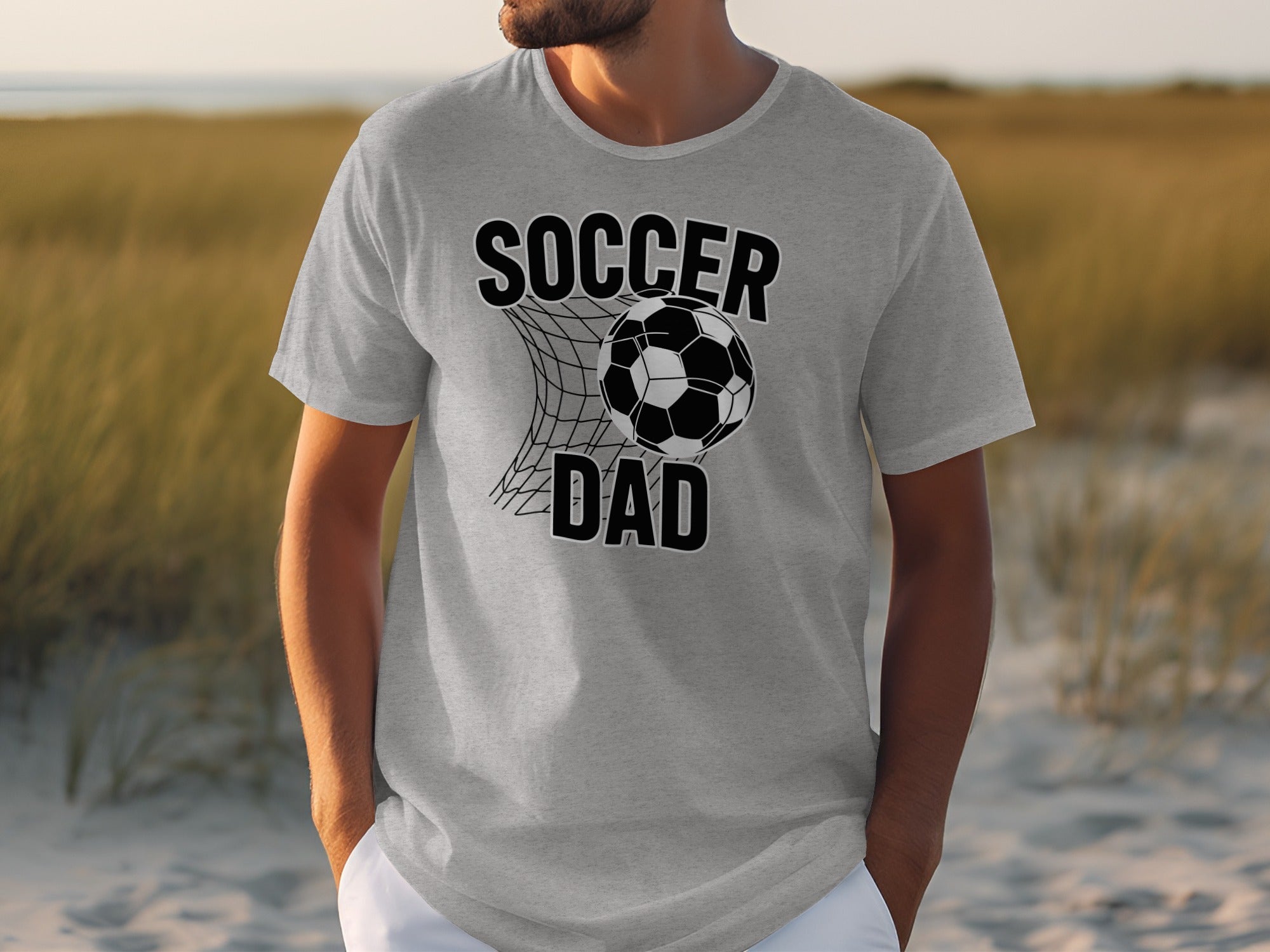 Grey t-shirt with "SOCCER DAD" text and soccer ball in net graphic