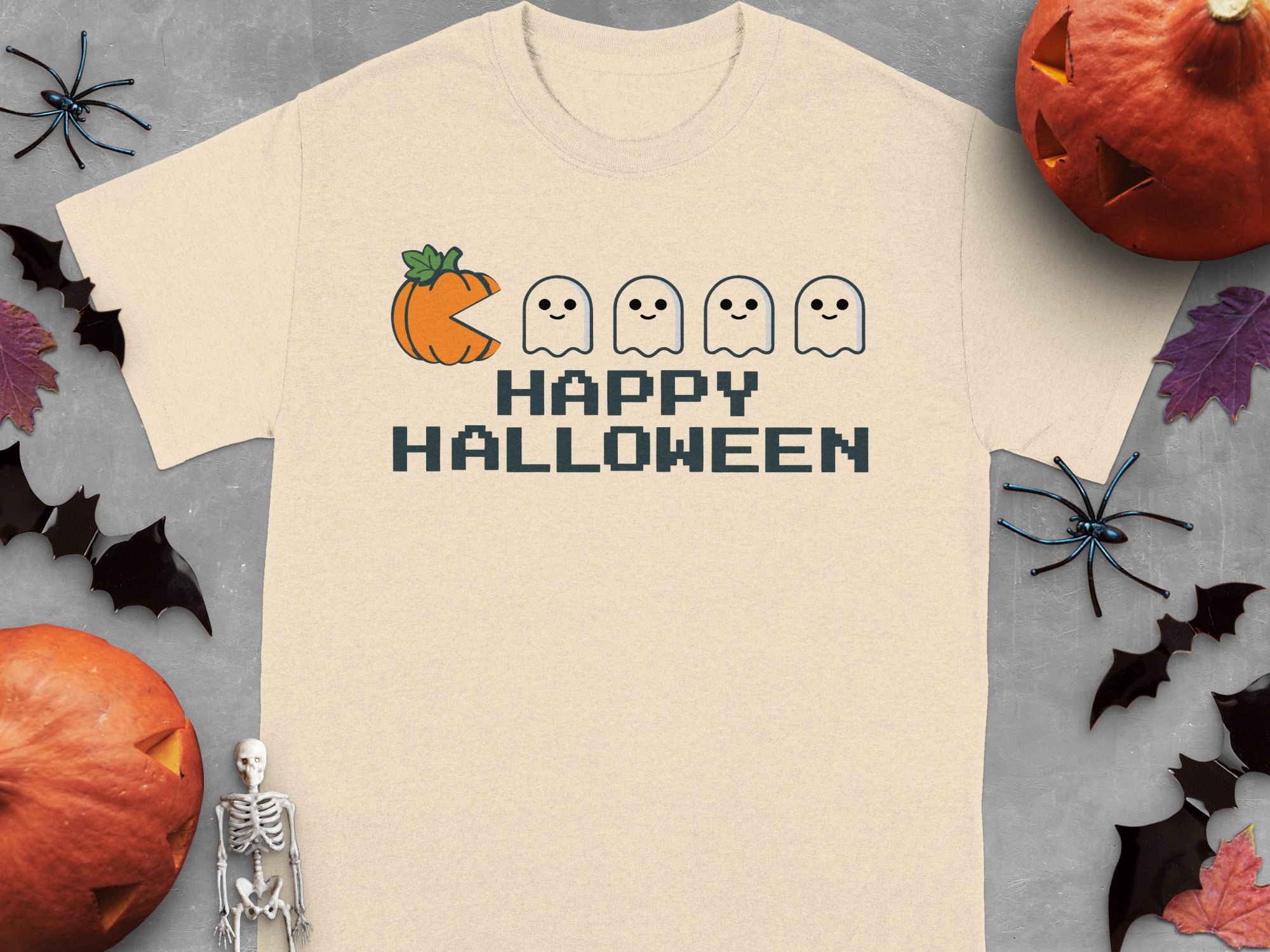 T-shirt with pixelated pumpkin, ghosts, and "Happy Halloween" text.