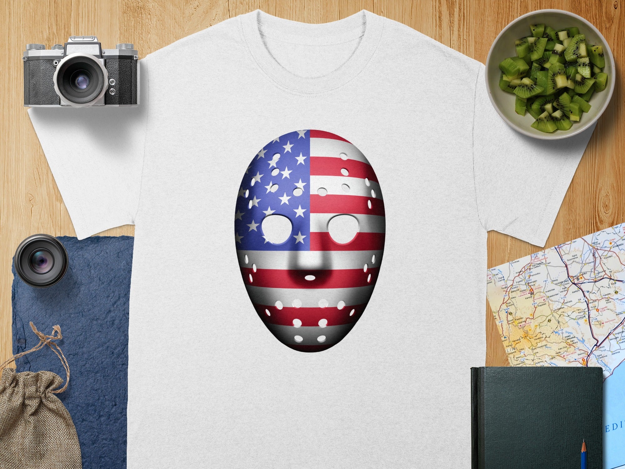 White t-shirt with an American flag hockey mask graphic.
