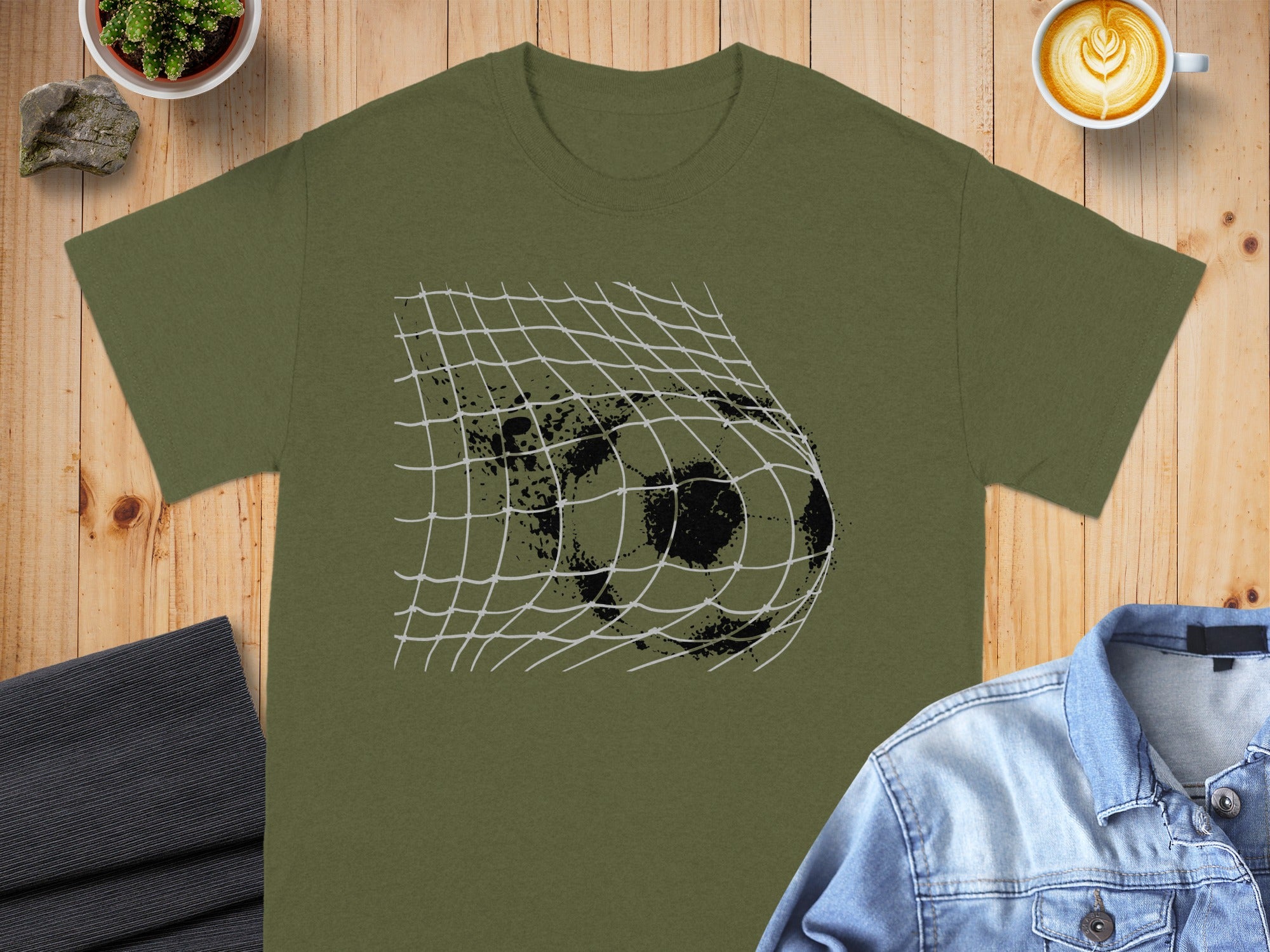Green t-shirt with a soccer ball hitting a net graphic.