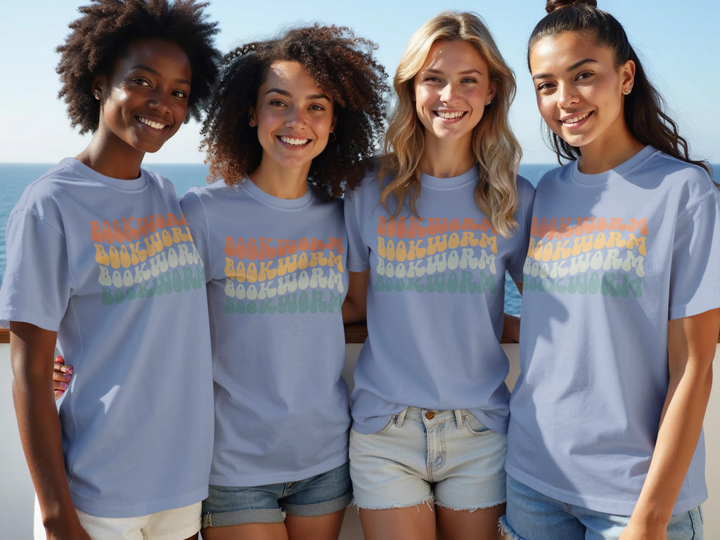 Four women wearing light blue t-shirts with "BOOKWORM" in retro lettering.