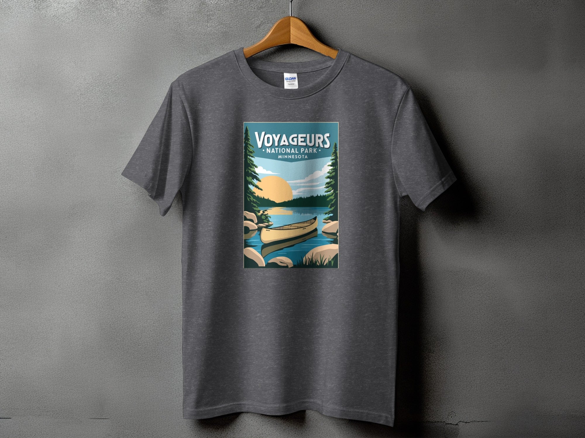 Voyageurs National Park Minnesota canoe and sunset graphic t-shirt on gray shirt.