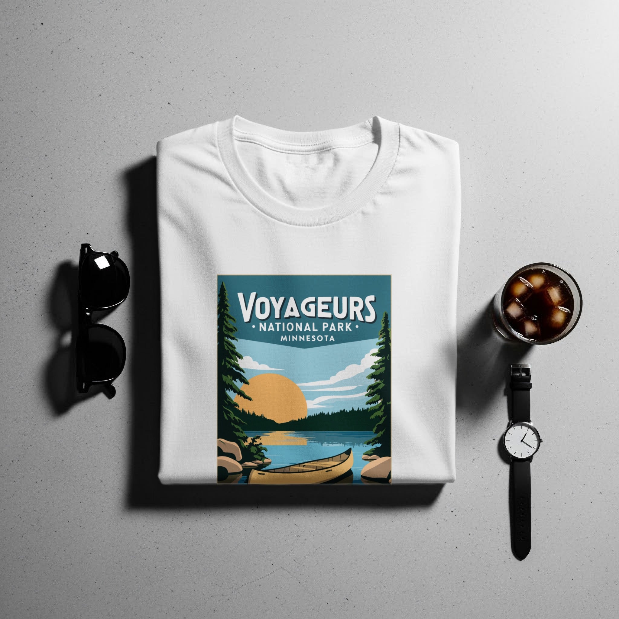 White t-shirt with Voyageurs National Park Minnesota graphic, canoe and sunset scene.