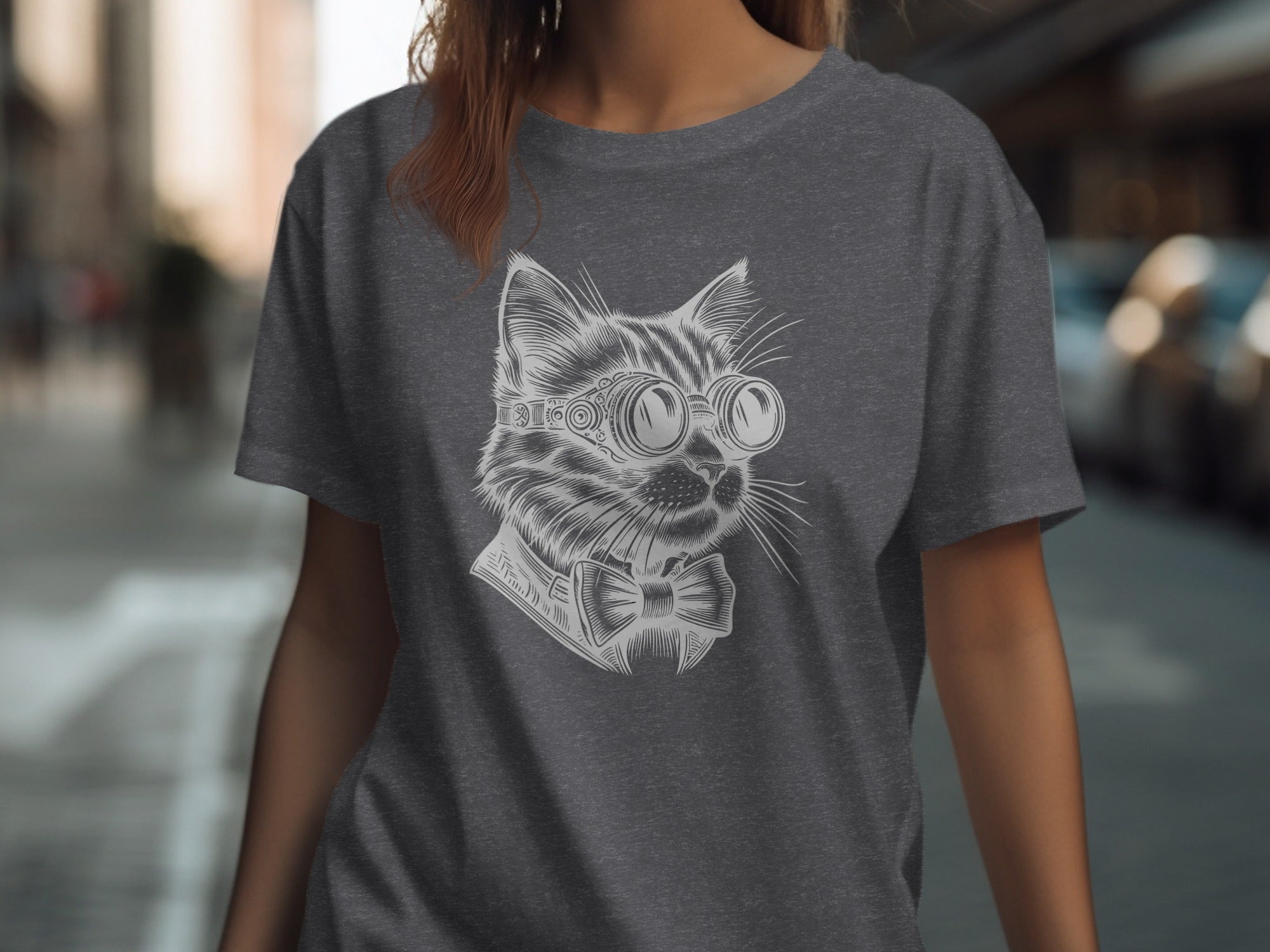 Dark grey t-shirt with a white line drawing of a cat wearing goggles and a bow tie.
