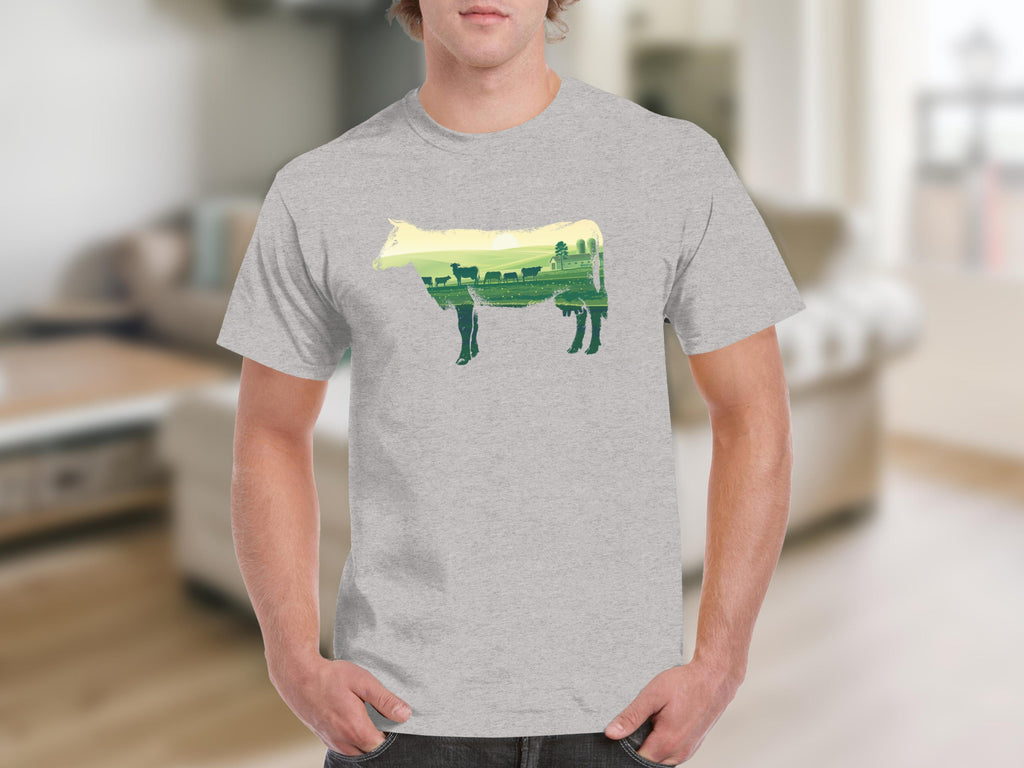 T-shirt with a cow silhouette filled with a farm landscape and cows.