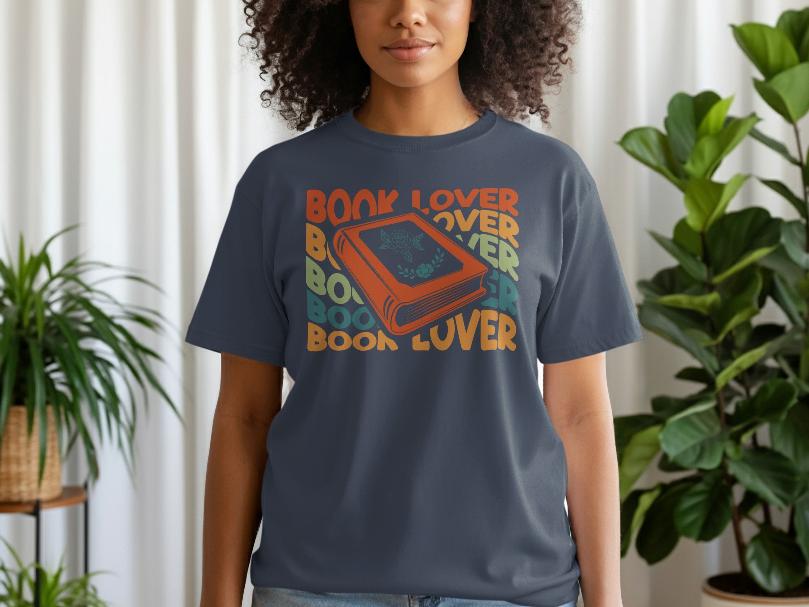 Dark grey t-shirt with "BOOK LOVER" text and an illustration of an orange book.