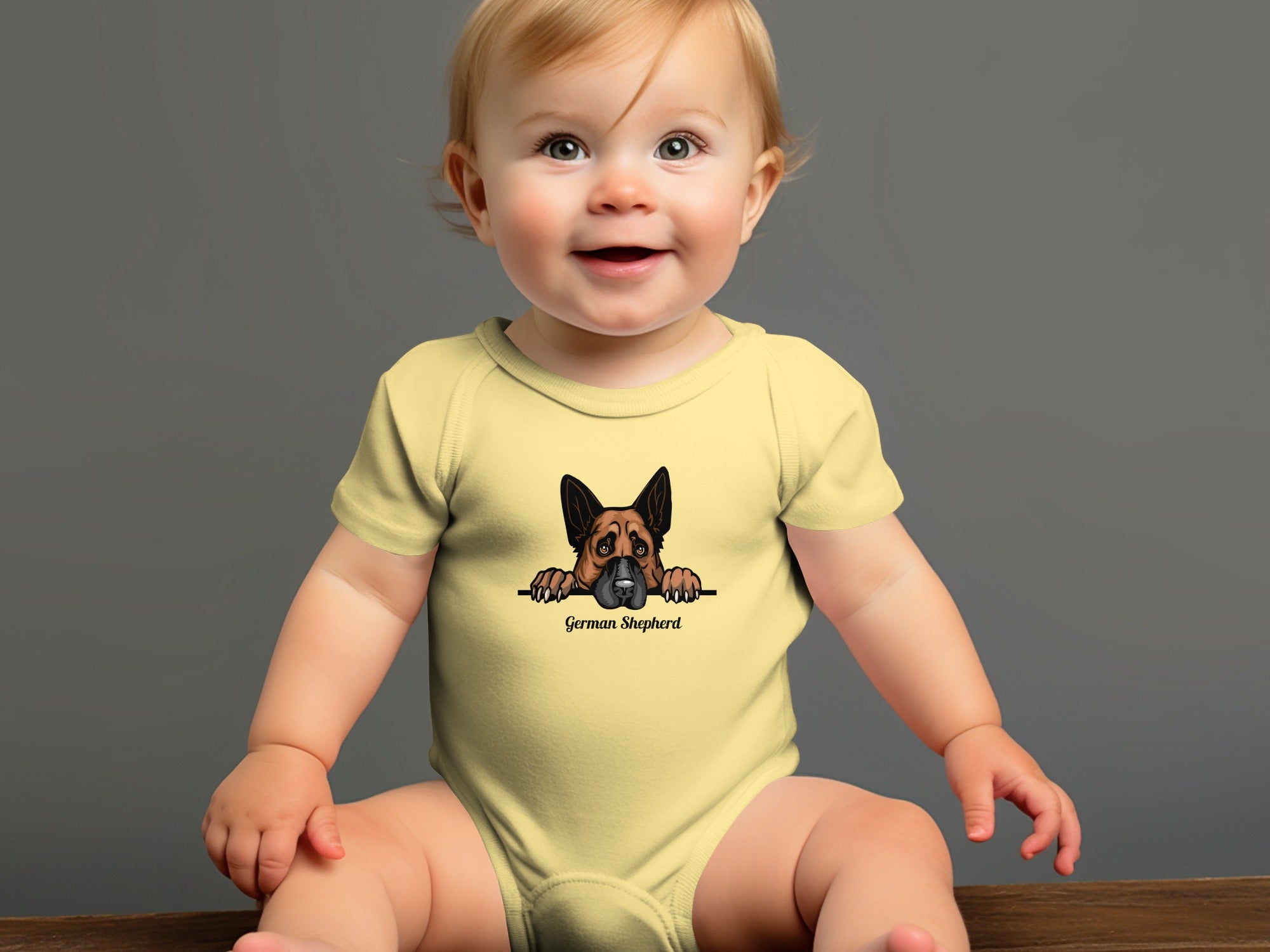 Baby wearing a yellow onesie with a German Shepherd graphic and text.