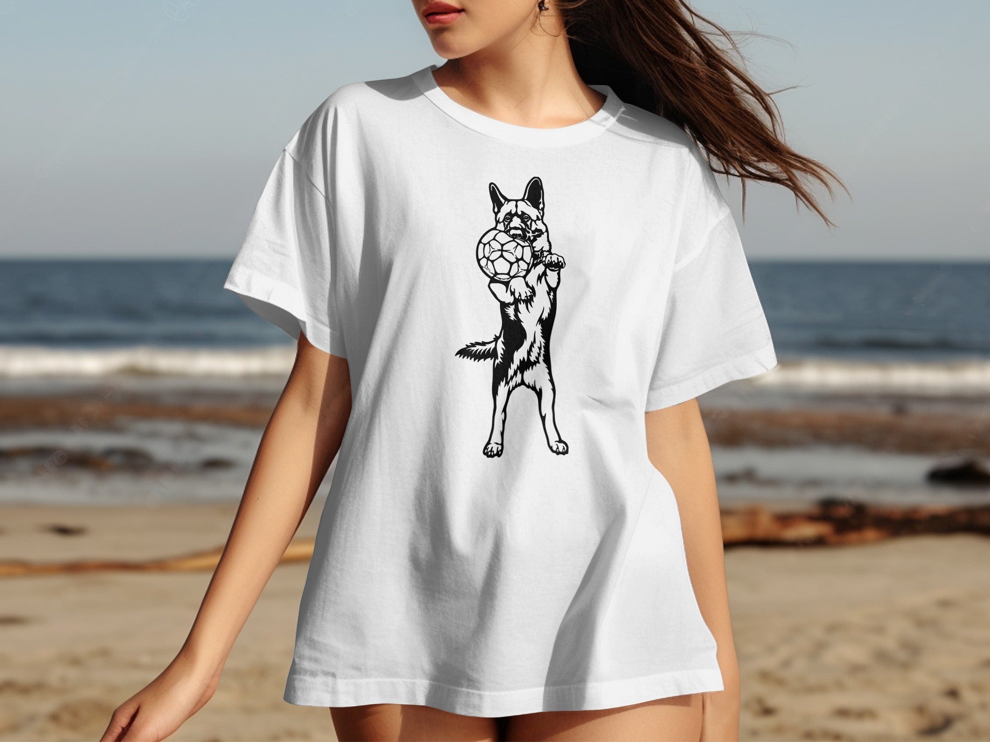 Black and white graphic of a dog holding a soccer ball on a white t-shirt.