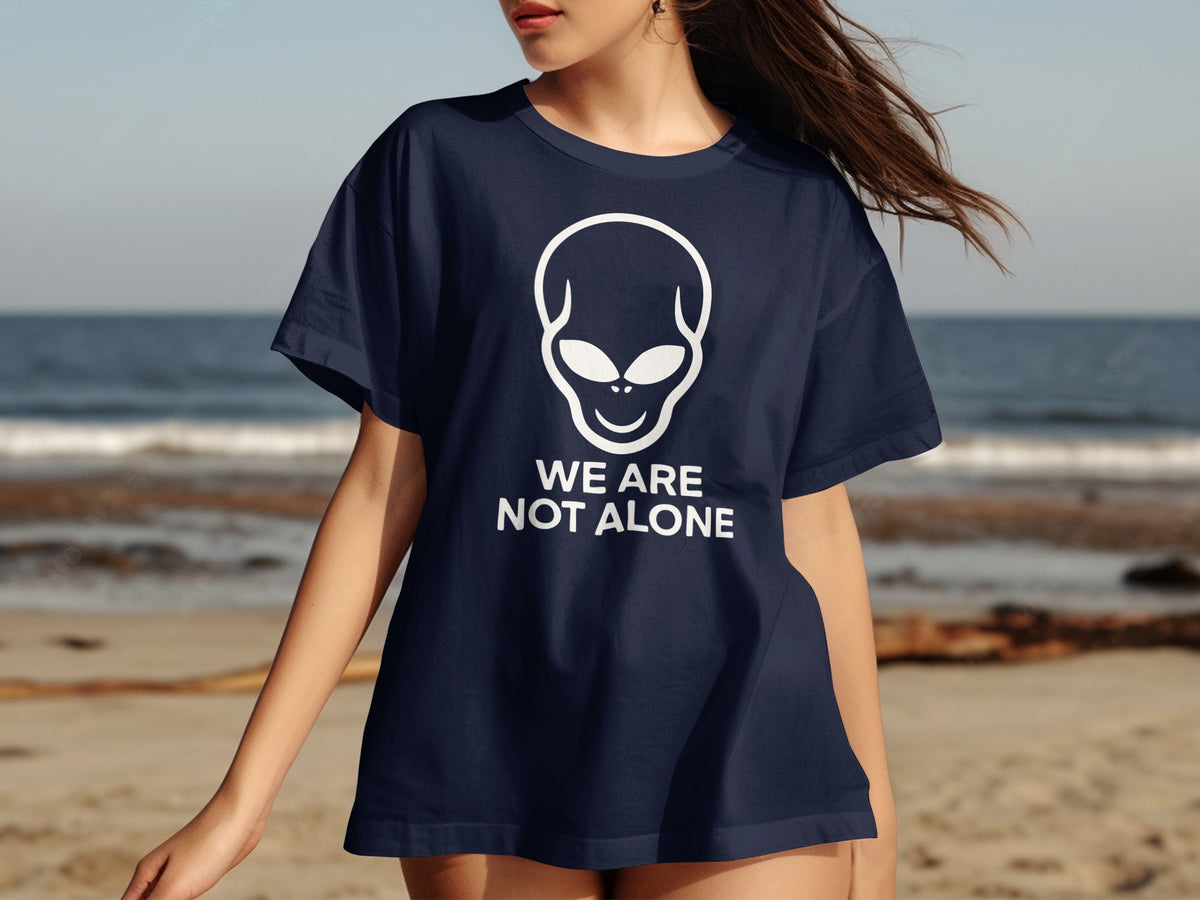 Dark blue t-shirt with white alien graphic and "WE ARE NOT ALONE" text.