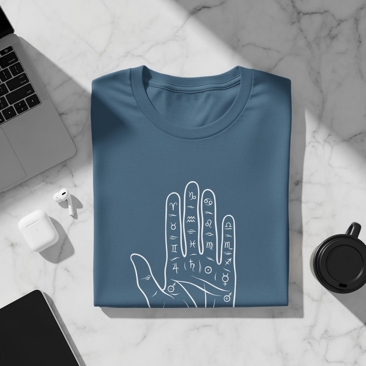 Blue t-shirt with a white line drawing of a palm with astrological symbols.