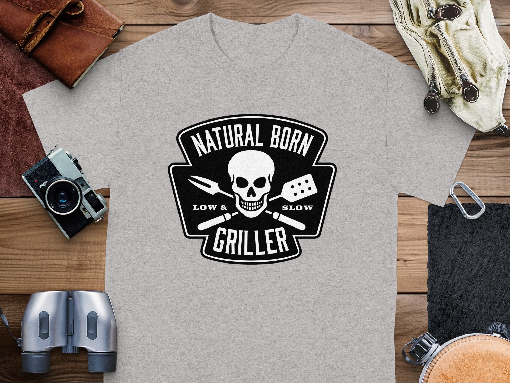 Grey t-shirt with "Natural Born Griller" skull and barbecue tools graphic.