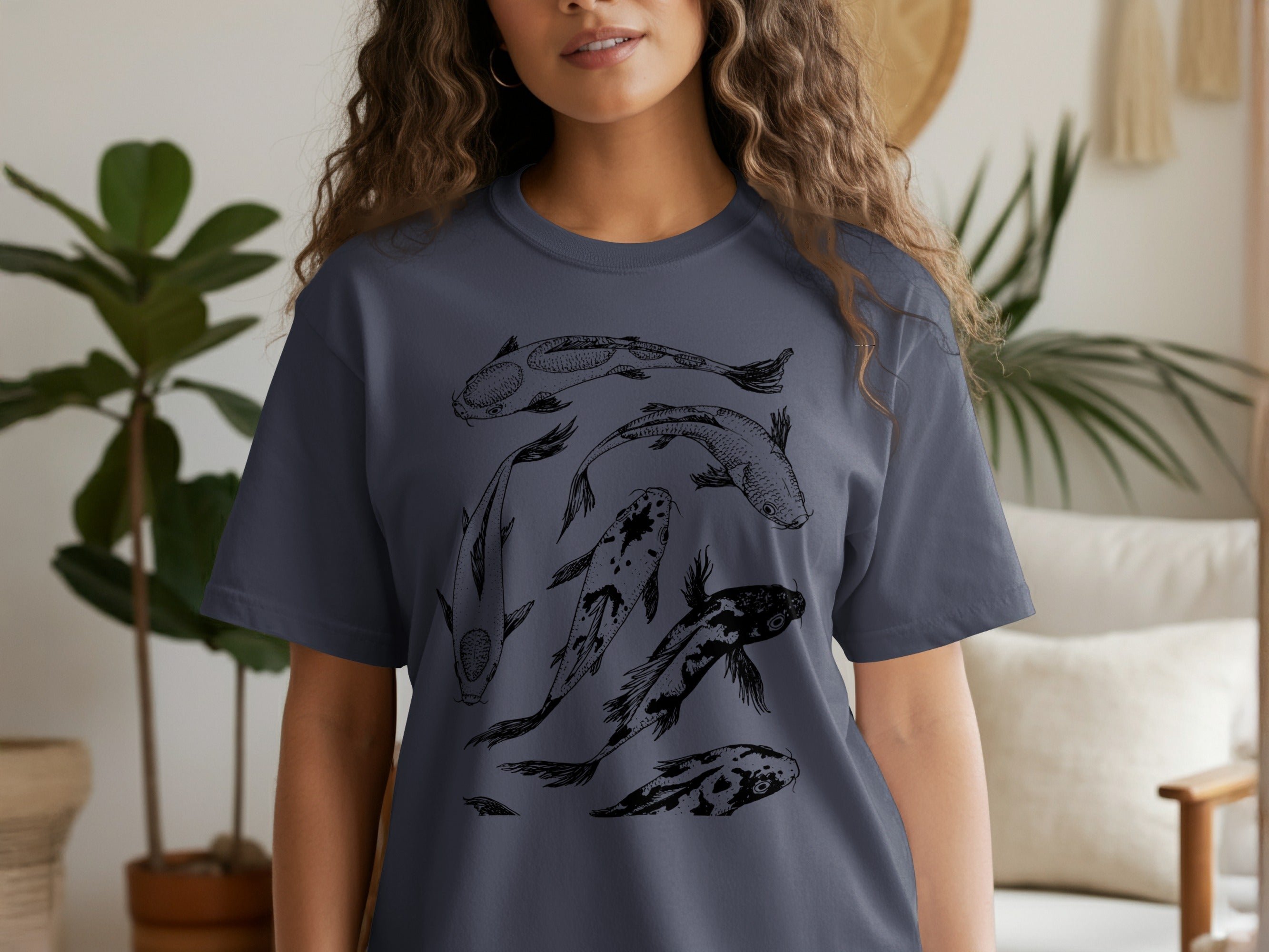 Dark grey t-shirt with a black ink drawing of several koi fish swimming.