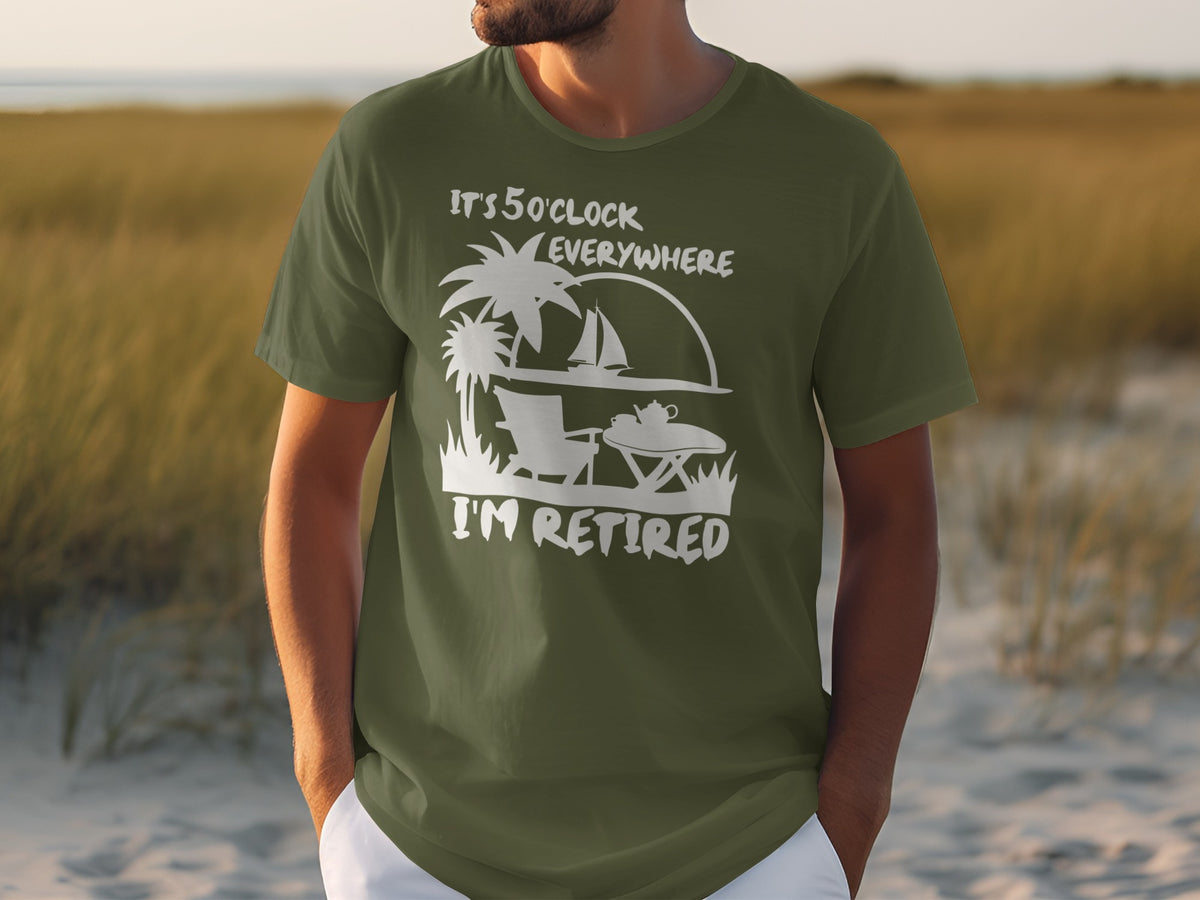 Green t-shirt with white graphic "It's 5 O'Clock Everywhere I'm Retired" and beach scene.