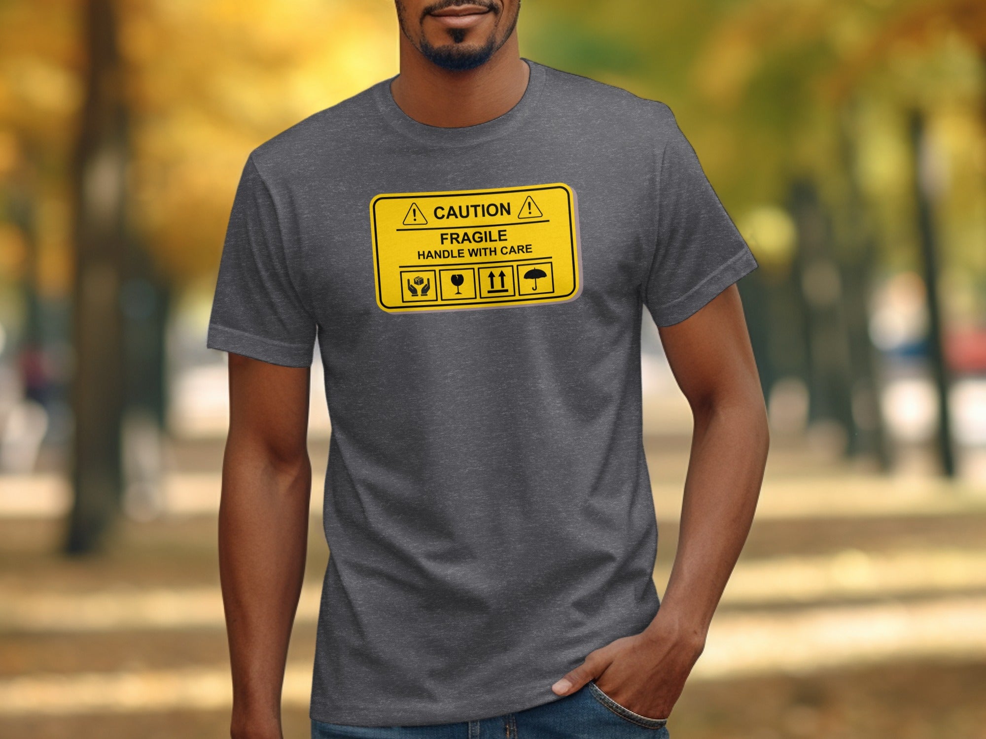 Dark gray t-shirt with a yellow "CAUTION FRAGILE HANDLE WITH CARE" warning sign graphic.