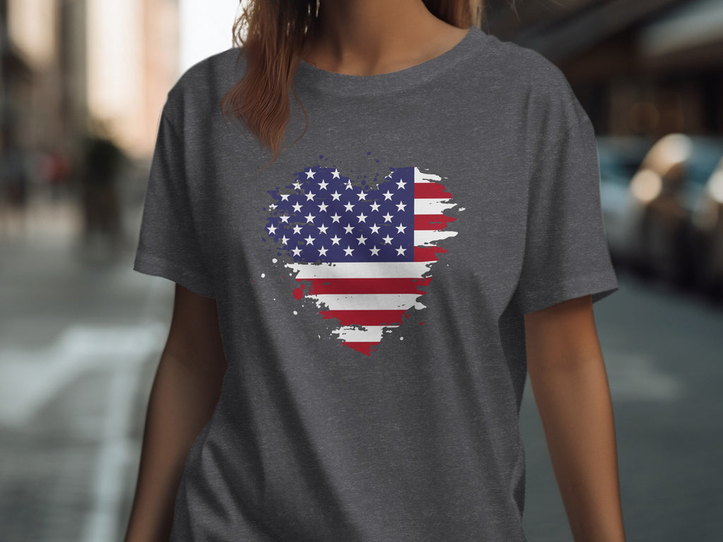 Grey t-shirt on a woman with an American flag heart graphic.