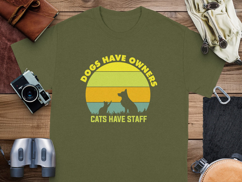 Olive t-shirt with circular graphic: "Dogs Have Owners, Cats Have Staff".
