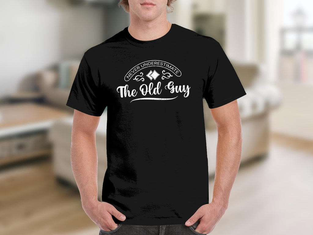 Black t-shirt with white text "Never Underestimate The Old Guy".