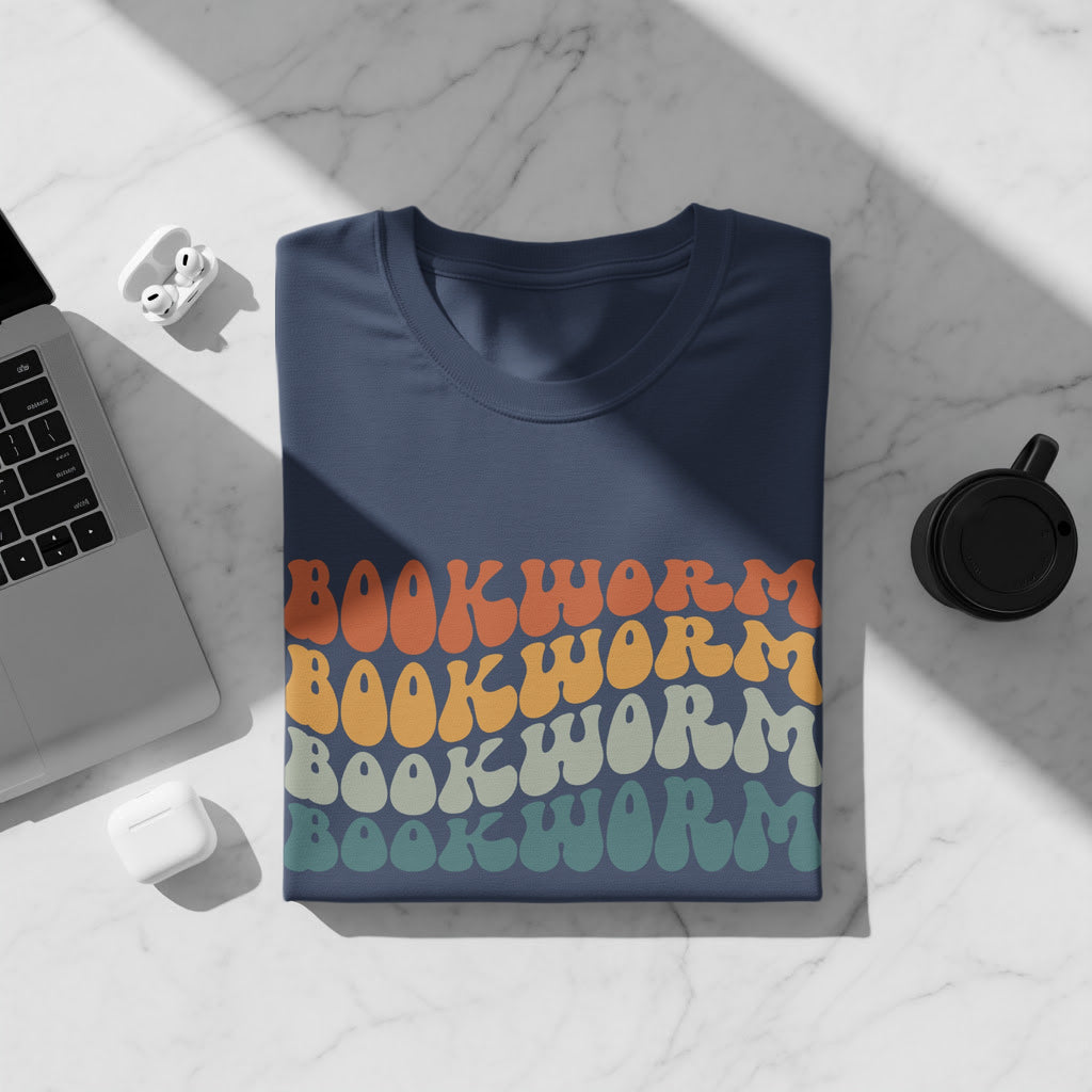 A navy t-shirt with retro "Bookworm" text in orange, yellow, grey, and teal.