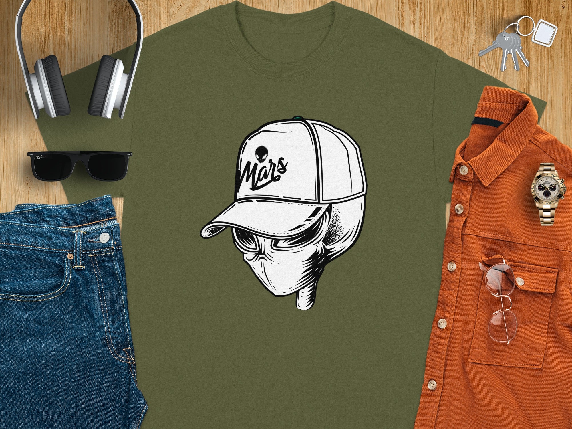 Green t-shirt graphic of an alien wearing a baseball cap with "Mars" text.
