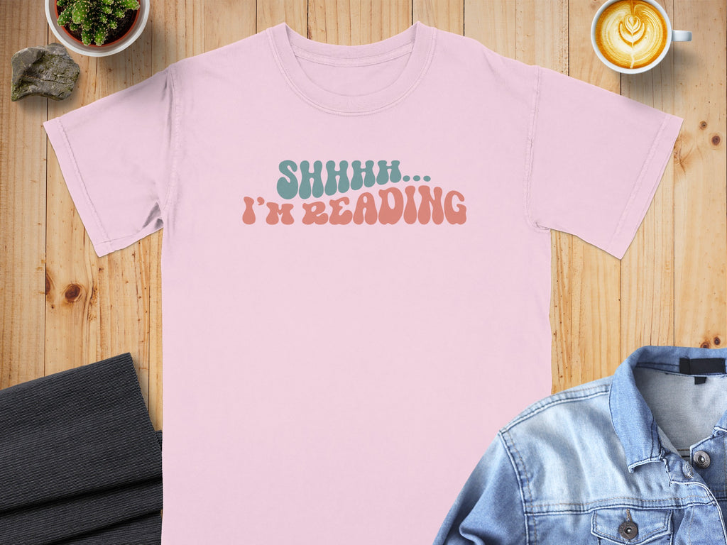 Pink t-shirt with "SHHHH... I'M READING" text in aqua and coral.