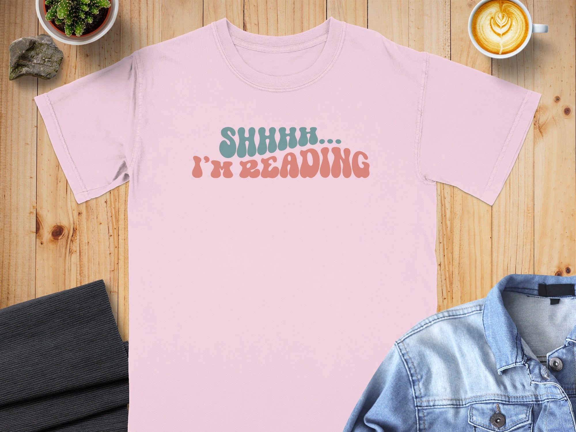 Pink t-shirt with "SHHHH... I'M READING" text in aqua and coral.