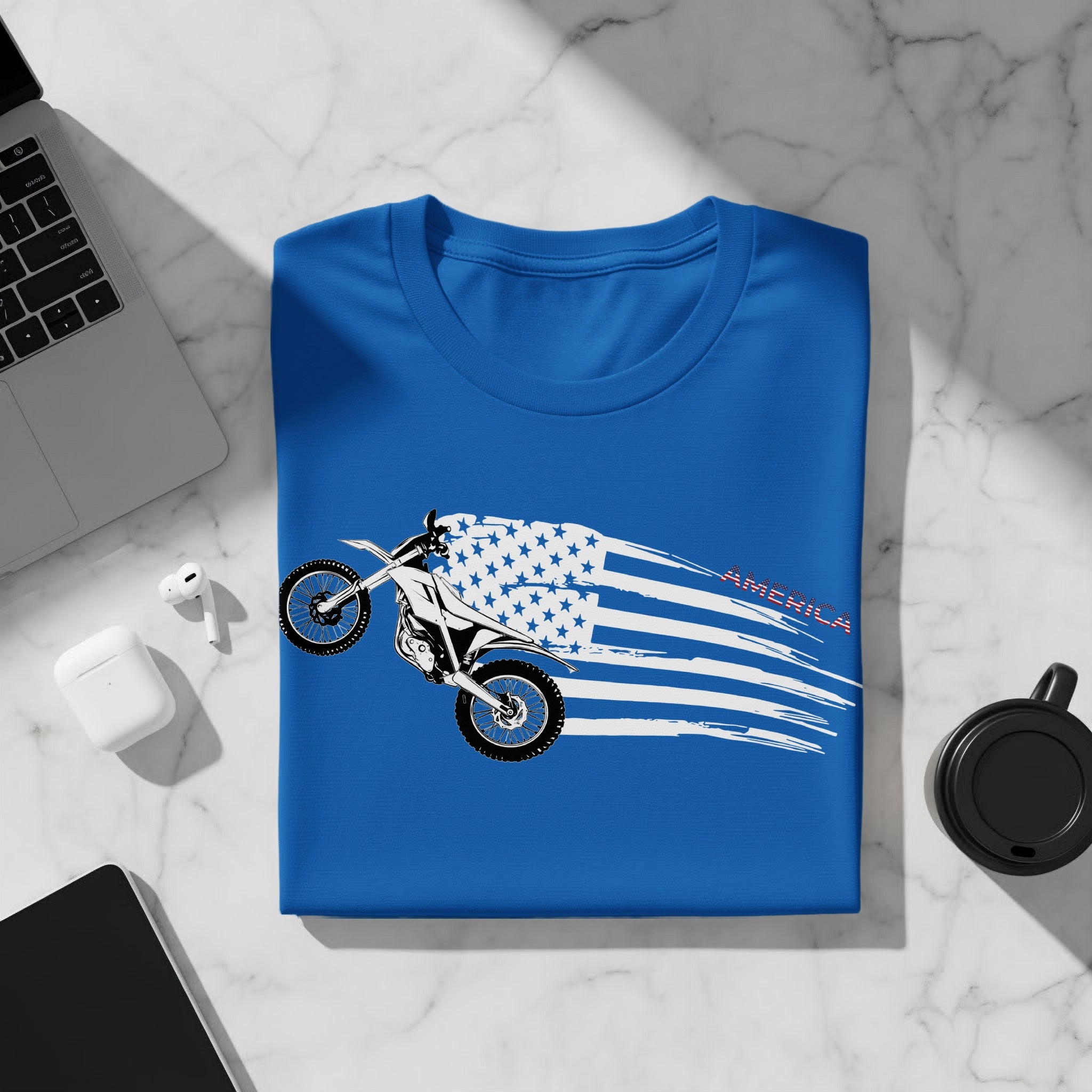 Blue t-shirt with a dirt bike on a distressed American flag with the word AMERICA.