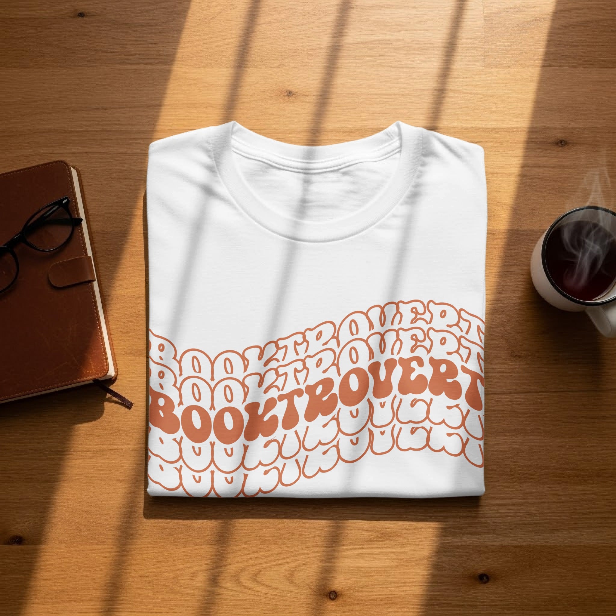 White t-shirt with "Booktrovert" text in a groovy orange font.